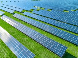 Solar panels producing green renewable energy. Solar power station in the field with green grass.